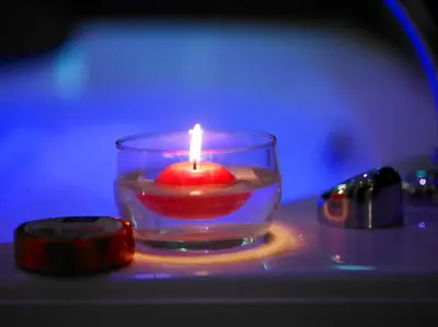 a candle in a glass bowl with a red liquid at Jazz Style in Rome