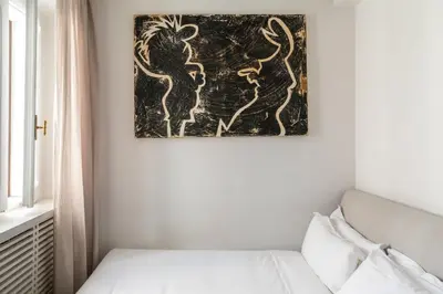a room with a bed and a painting on the wall at BDB Rooms Margutta in Rome