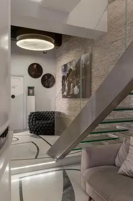a living room with a staircase and a couch at BDB Rooms Margutta in Rome