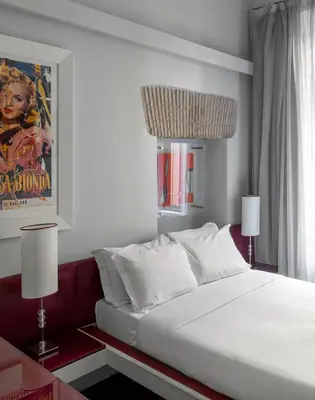 a bedroom with a large white bed and two lamps at BDB Rooms Margutta in Rome