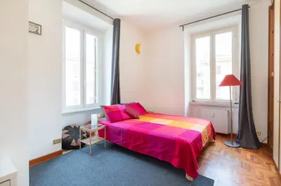 a bedroom with a bed with a colorful blanket at Like At Home Piramide in Rome