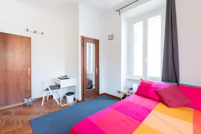 a bedroom with a colorful bed and a desk at Like At Home Piramide in Rome