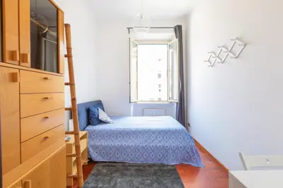 a small bedroom with a bed and a window at Like At Home Piramide in Rome