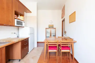 a kitchen with a table and chairs in a room at Like At Home Piramide in Rome