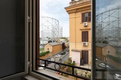 a view from a window with a roller coaster in the background at Like At Home Piramide in Rome