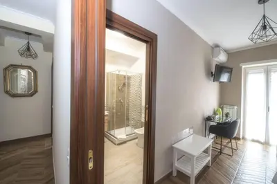 a hallway with a door leading to a bathroom at Bed & Breakfast Vacanze Romane in Rome