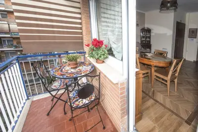 a balcony with two chairs and a table on it at Bed & Breakfast Vacanze Romane in Rome