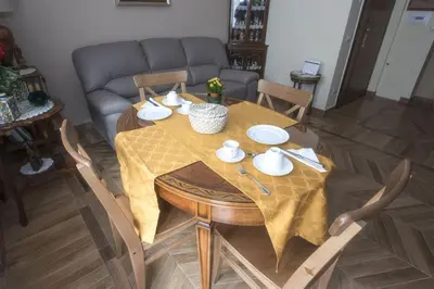 a table with plates and bowls on it in a living room at Bed & Breakfast Vacanze Romane in Rome