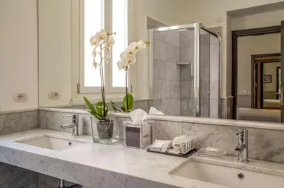 a bathroom with a sink and a mirror at Nazionale 51 L Rooms in Rome