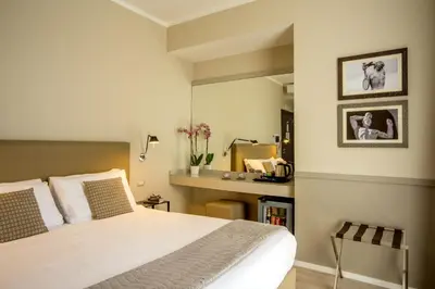 a bedroom with a large bed and a mirror at Nazionale 51 L Rooms in Rome