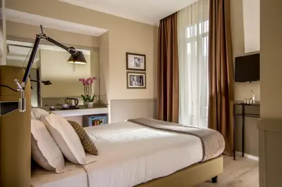 a hotel room with a bed and a window at Nazionale 51 L Rooms in Rome