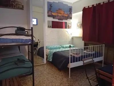 a bedroom with two bunk beds and a mirror at Roma Trastevere Station in Rome