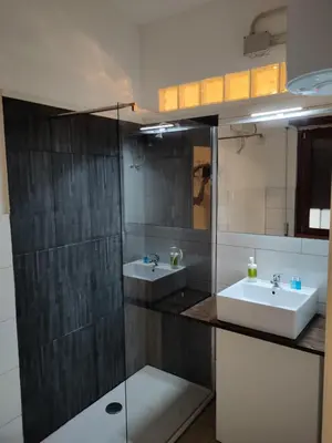 a bathroom with two sinks and a glass shower at Roma Trastevere Station in Rome