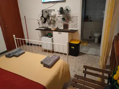 a room with a bed and a bathroom with a toilet at Roma Trastevere Station in Rome
