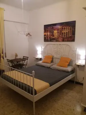 a bedroom with two beds with orange pillows at Roma Trastevere Station in Rome