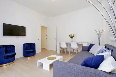 a living room with a couch and chairs and a table at My Little Holiday in Rome