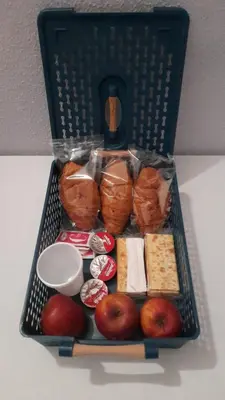 a basket full of food with apples and bread at guesthouse ava roma in Rome