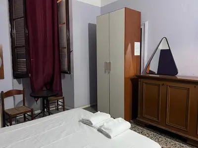 a bedroom with a bed and a dresser and a mirror at guesthouse ava roma in Rome