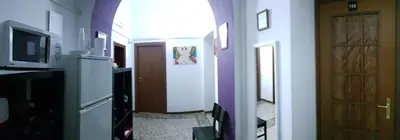 a room with a hallway with a door and a television at guesthouse ava roma in Rome