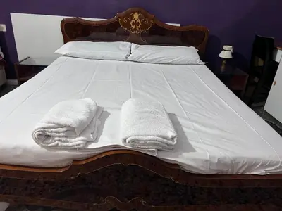 a bed with two white towels on it at guesthouse ava roma in Rome