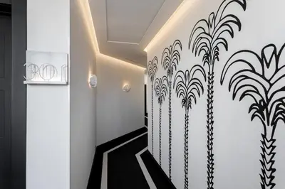 a hallway with black and white walls and a black and white staircase at Room Mate Collection Filippo, Rome-Fontana di Trevi in Rome