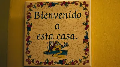 a sign on a wall that says bernardino a extra casa at Casa Particular 25Rooms in Rome