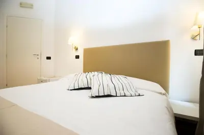 a white bed with two pillows on top of it at I Mulini A Vento in Rome