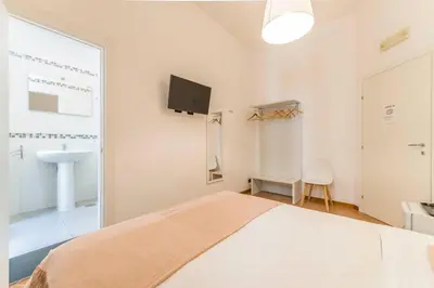 a white bedroom with a bed and a sink at I Mulini A Vento in Rome