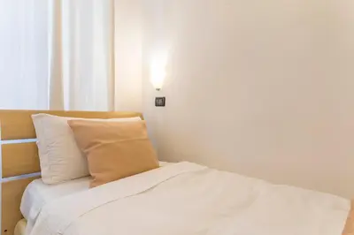 a bedroom with a bed and a light on the wall at I Mulini A Vento in Rome