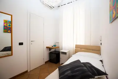 a small bedroom with a bed and a mirror at I Mulini A Vento in Rome