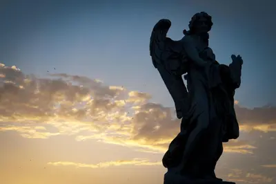 a statue of an angel with the sky in the background at Rome Services Porta Castello in Rome