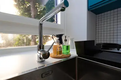 a kitchen sink with a faucet next to a window at Donatello Loft in Rome