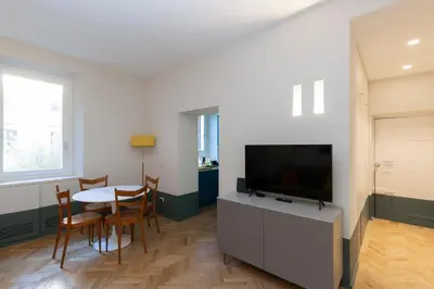 a living room with a table and a flat screen tv at Donatello Loft in Rome