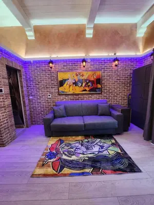 a living room with a couch and a brick wall at THE IMPERIAL SUITE e THE BRICKS in Rome