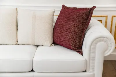 a white couch with a red pillow on it at THE IMPERIAL SUITE e THE BRICKS in Rome