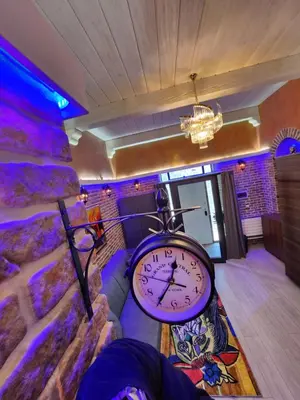 a room with a clock in a room with purple lights at THE IMPERIAL SUITE e THE BRICKS in Rome