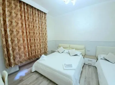 a bedroom with two beds and a curtain at Oscar suite home in Rome