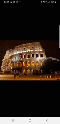 a large building with a christmas tree in front of it at Oscar suite home in Rome