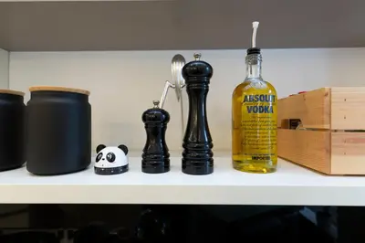 a shelf with a bottle of alcohol and chess pieces at B & Bea in Rome