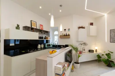 a kitchen with white cabinets and a counter top at B & Bea in Rome