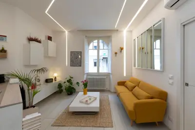a living room with a yellow couch and a table at B & Bea in Rome