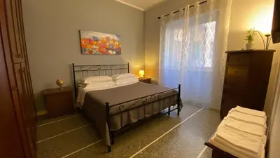 a bedroom with a bed and a dresser and a window at La Dimora in Rome