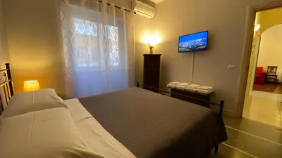 a bedroom with a bed and a flat screen tv at La Dimora in Rome