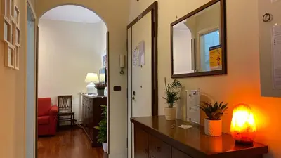 a hallway with a desk with a light and a mirror at La Dimora in Rome