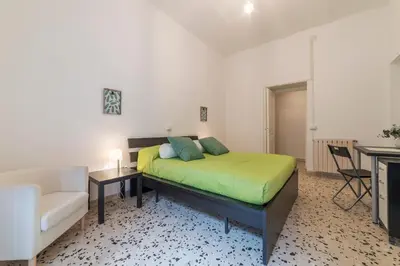 a bedroom with a bed and a couch and a chair at GuestHost - Ad un passo da Villa Borghese Apartment in Rome