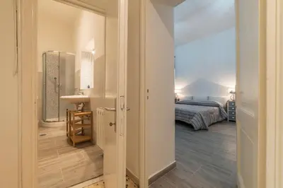 a bathroom with a sink and a bed in a room at GuestHost - Ad un passo da Villa Borghese Apartment in Rome