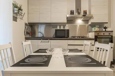 a kitchen with a table and chairs in a kitchen at GuestHost - Ad un passo da Villa Borghese Apartment in Rome