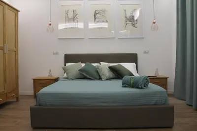 a bedroom with a bed with two pillows on it at Nannarè Guest House in Rome