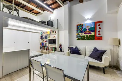 a kitchen and living room with a white table and chairs at Rome Historic Center LOFT in Rome