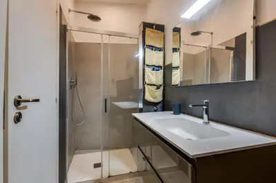 a bathroom with a sink and a shower at Rome Historic Center LOFT in Rome